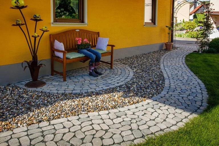 Steingartenweg mit Pflastersteinen Arena und Begrünung, Gartengestaltung von Bella Flora GmbH.