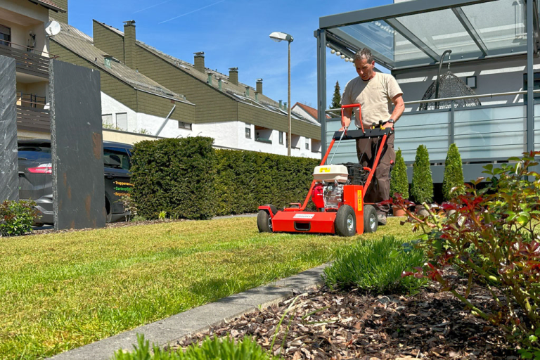Fachgerechtes Vertikutieren und Rasenpflege mit Profigerät im Privatgarten als Gartenpflege-Leistung in Wiesenttal von BELLA FLORA GmbH.