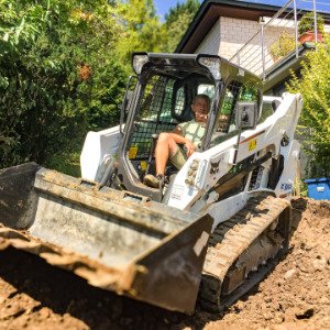 Erdarbeiten mit Kompaktkettenlader beim Abtrag und Planieren von Boden für den Garten- und Landschaftsbau in Reuth von BELLA FLORA GmbH.